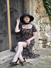 A woman wears a floral ruched dress